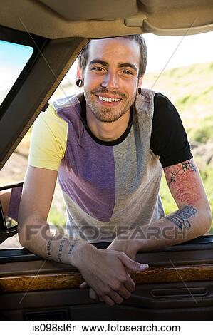Stock Photography - Young man by automobile. Fotosearch