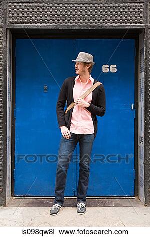 Young man by door View Large Photo Image Stock Image - Young man by door. Fotosearch