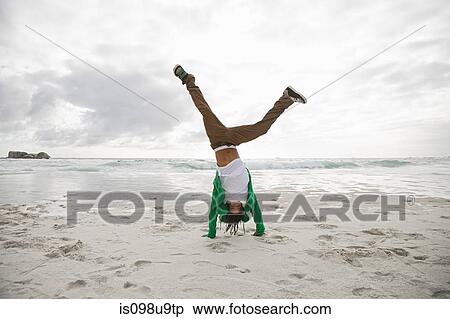 Young man doing cartwheels on beach View Large Photo Image Stock Photography - Young man doing cartwheels on beach. Fotosearch
