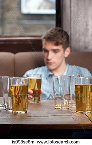 Picture - Young man in bar. Fotosearch