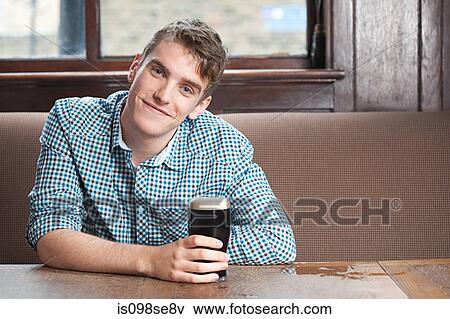 Young man in bar View Large Photo Image Stock Photo - Young man in bar. Fotosearch