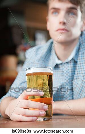 Stock Photograph - Young man in bar. Fotosearch