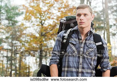 Stock Photo - Young man in forest. Fotosearch