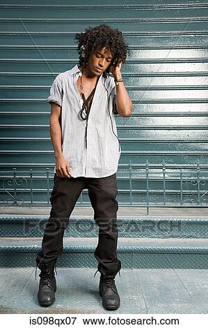 Stock Photo - Young man listening to music. Fotosearch