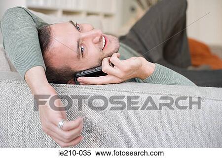 Stock Photography - Young man on cellphone. Fotosearch