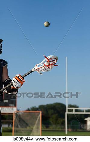 Stock Photo - Young man playing lacrosse. Fotosearch