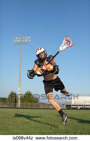 Stock Photo - Young man playing lacrosse. Fotosearch