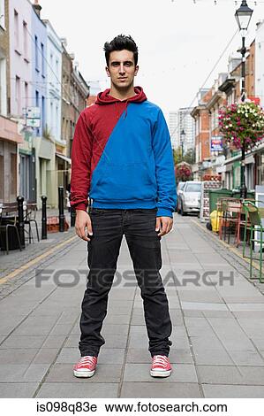Young man standing in street View Large Photo Image Stock Image - Young man standing in street. Fotosearch