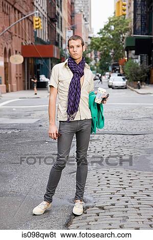 Young man standing in street View Large Photo Image Stock Photograph - Young man standing in street. Fotosearch