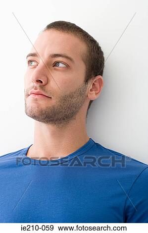 Stock Photo - Young man thinking. Fotosearch