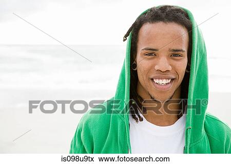 Young man with green hooded top, portrait View Large Photo Image Stock Photo - Young man with green hooded top, portrait. Fotosearch