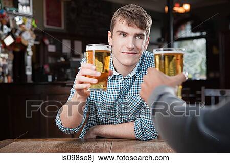 Young men in bar View Large Photo Image Stock Image - Young men in bar. Fotosearch
