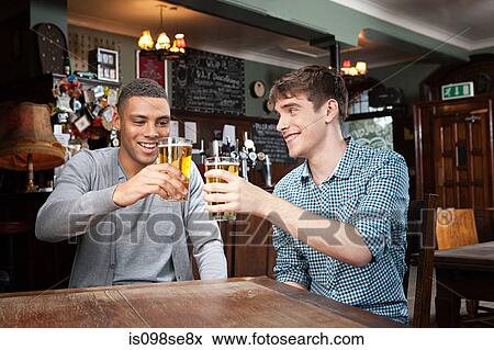 Stock Photo - Young men in bar. Fotosearch