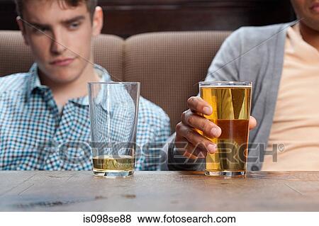 Stock Photo - Young men in bar with beer. Fotosearch