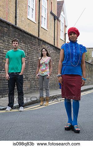 Stock Image - Young people standing in street. Fotosearch