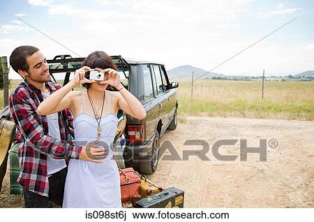 Young woman and boyfriend with digital camera View Large Photo Image Stock Image - Young woman and boyfriend with digital camera. Fotosearch