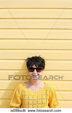Young woman and yellow wall View Large Photo Image Stock Image - Young woman and yellow wall. Fotosearch