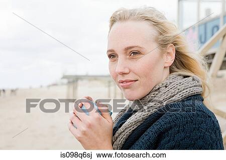 Young woman at the coast View Large Photo Image Stock Image - Young woman at the coast. Fotosearch