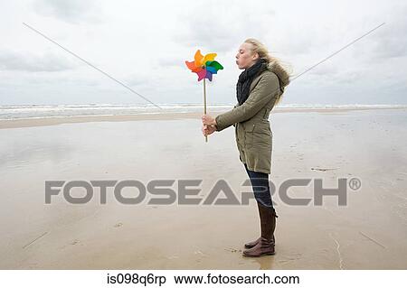 Young woman by sea with pinwheel View Large Photo Image Stock Photography - Young woman by sea with pinwheel. Fotosearch