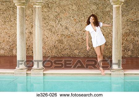 Stock Photograph - Young woman by swimming pool. Fotosearch