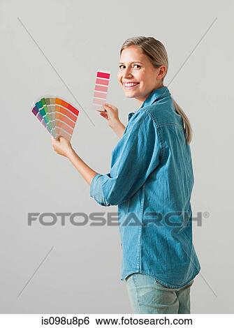 Young woman choosing paint color View Large Photo Image Stock Photograph - Young woman choosing paint color. Fotosearch