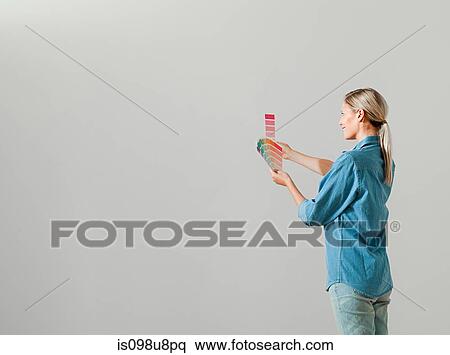 Young woman choosing paint color View Large Photo Image Stock Photography - Young woman choosing paint color. Fotosearch