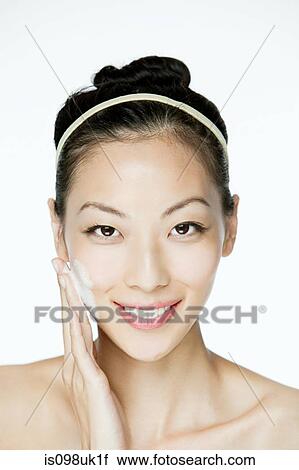 Young woman cleansing her face View Large Photo Image Stock Image - Young woman cleansing her face. Fotosearch