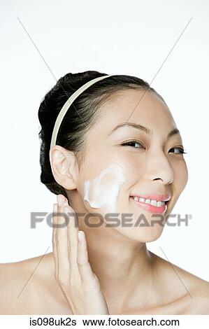 Young woman cleansing her face View Large Photo Image Stock Photograph - Young woman cleansing her face. Fotosearch