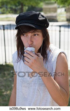 Young woman eating a snow cone View Large Photo Image Stock Photograph - Young woman eating a snow cone. Fotosearch