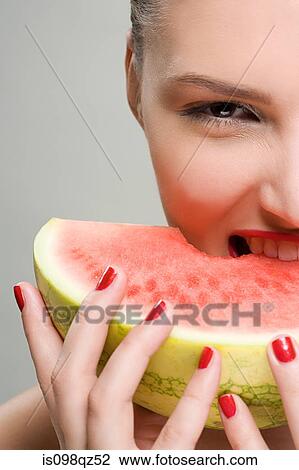 Young woman eating watermelon View Large Photo Image Stock Image - Young woman eating watermelon. Fotosearch
