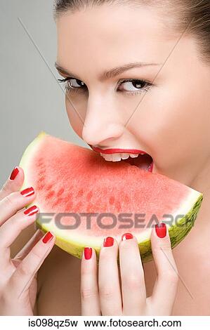 Young woman eating watermelon View Large Photo Image Stock Photo - Young woman eating watermelon. Fotosearch