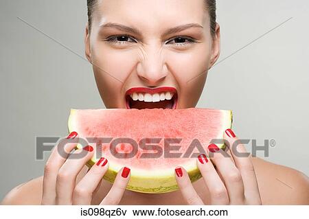 Stock Photo - Young woman eating watermelon. Fotosearch