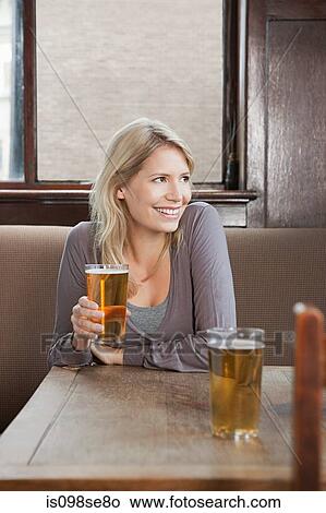 Young woman in bar View Large Photo Image Picture - Young woman in bar. Fotosearch