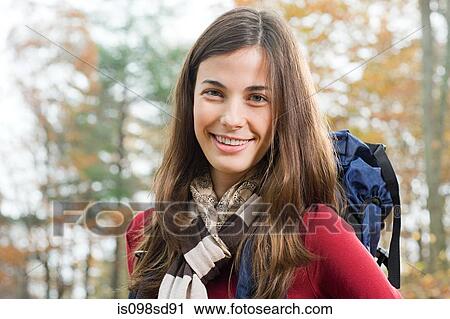 Stock Image - Young woman in forest. Fotosearch