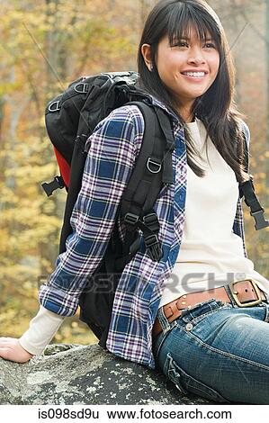Young woman in forest with backpack View Large Photo Image Stock Photograph - Young woman in forest with backpack. Fotosearch