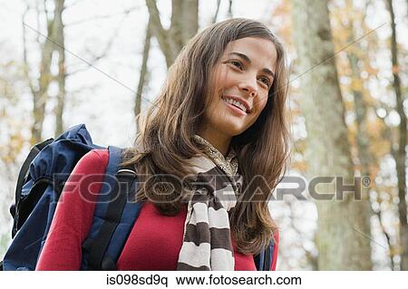 Young woman in forest with backpack View Large Photo Image Stock Photography - Young woman in forest with backpack. Fotosearch