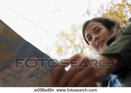Picture - Young woman looking at map. Fotosearch