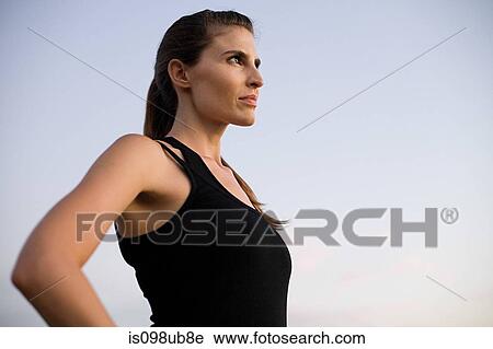 Stock Image - Young woman looking away. Fotosearch