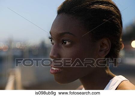 Stock Image - Young woman looking away. Fotosearch