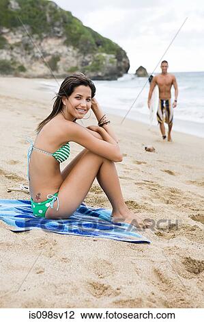 Stock Image - Young woman on a beach. Fotosearch