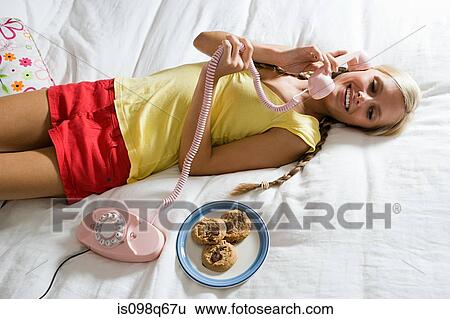 Stock Photograph - Young woman on telephone. Fotosearch