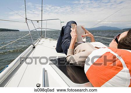 Young woman reading on a boat View Large Photo Image Stock Image - Young woman reading on a boat. Fotosearch