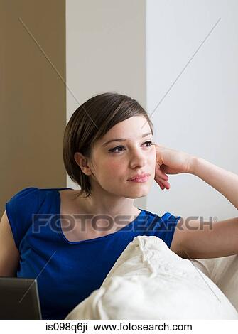 Stock Image - Young woman thinking. Fotosearch