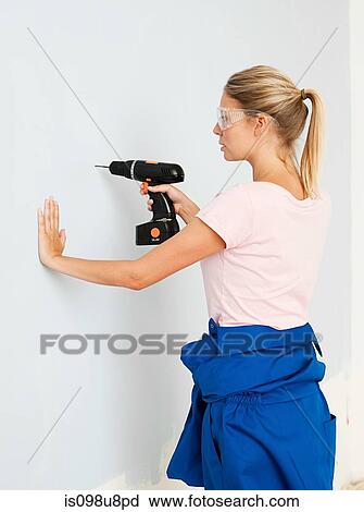 Young woman using electric drill View Large Photo Image Stock Image - Young woman using electric drill. Fotosearch