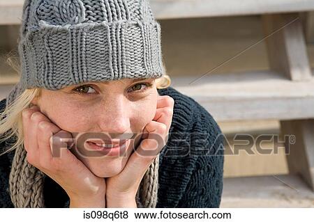 Stock Photo - Young woman wearing a hat. Fotosearch