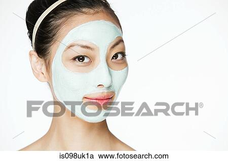 Stock Image - Young woman wearing face mask. Fotosearch