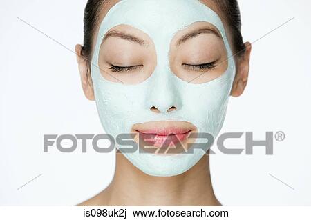 Stock Image - Young woman wearing face mask. Fotosearch