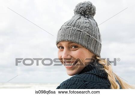 Young woman wearing knit hat View Large Photo Image Stock Image - Young woman wearing knit hat. Fotosearch