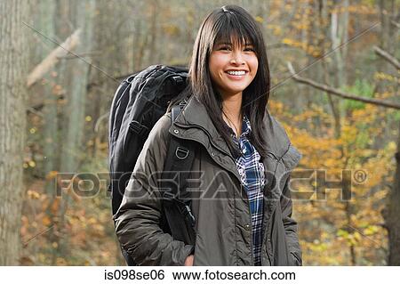 Young woman with backpack in forest View Large Photo Image Stock Photograph - Young woman with backpack in forest. Fotosearch