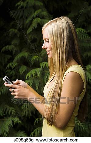 Young woman with cellphone View Large Photo Image Stock Image - Young woman with cellphone. Fotosearch